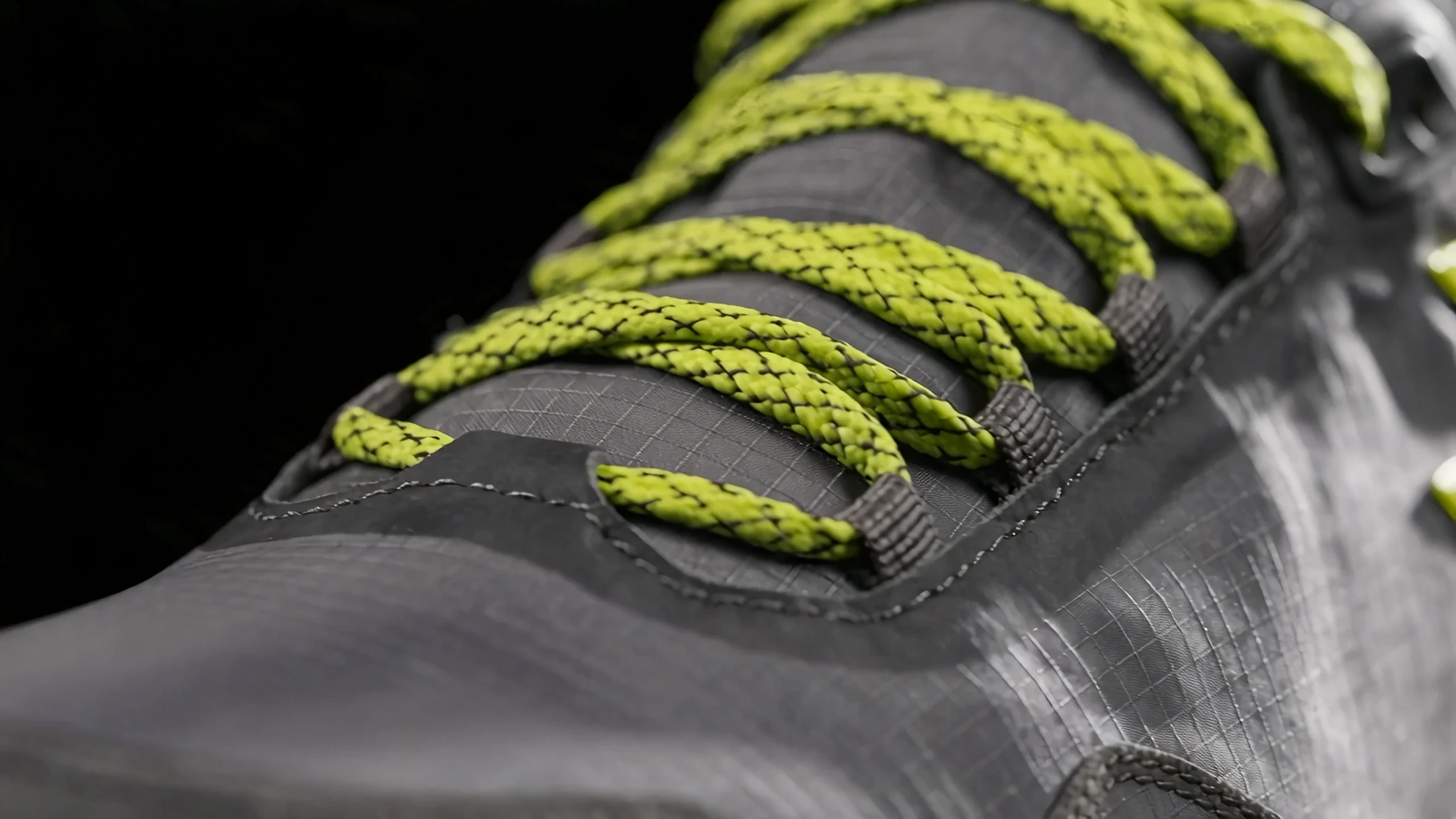 Close-up of woven laces, mesh texture, and the shoe’s stitched construction