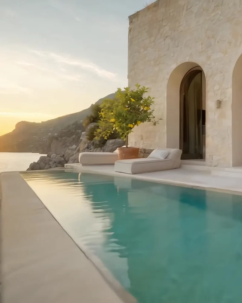 A sunlit terrace and lemon trees beside the infinity pool